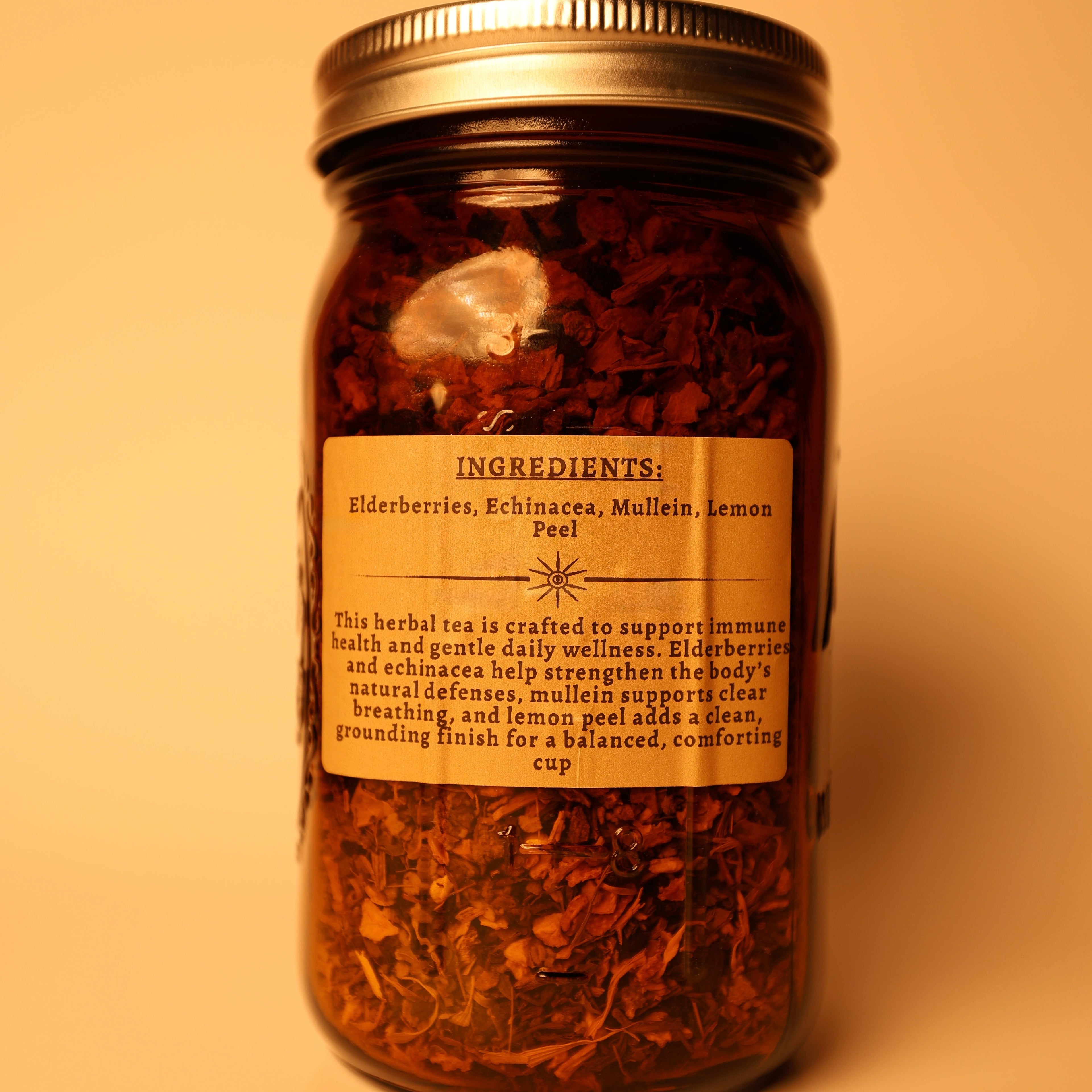 Ingredients Sambucus (Elderberries), Echinacea Purperea (Echinacea), Vetbascum (Mullein), Citrus Limon Peel (Lemon Peel)abel on the back of the jar. A tea sold by madMuchLove Holistic Healing. 